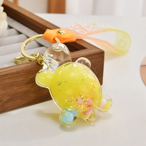 Detailed macro view of yellow turtle keychain with flowing sand and BUBU strap