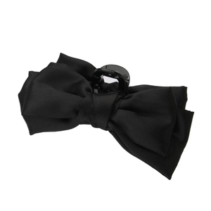 Detail showing the inner resin spring claw of the black satin oversized bow hair clip