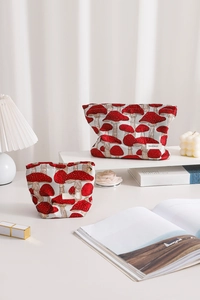 Detail of vintage mushroom jacquard toiletry bag with heart-shaped zipper and label