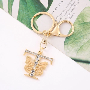Detail of gold letter T keychain with crystal butterfly and sparkling rhinestones