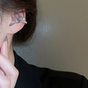 Detailed view of silver snake-shaped cuff earring with sparkling zircon inlays for women