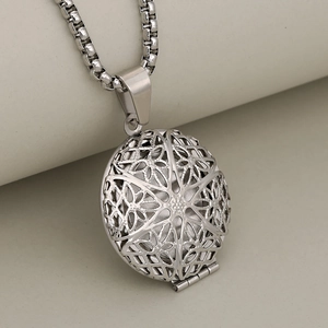 Vintage round stainless steel locket necklace with hollow floral pattern in silver