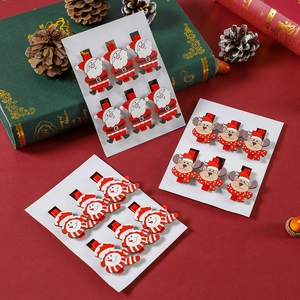 Detail of 6pcs Christmas wooden clips with Santa and Reindeer on a festive background