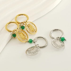 Gold and silver sun charm hoop earrings with green beads and hollow sun pendants