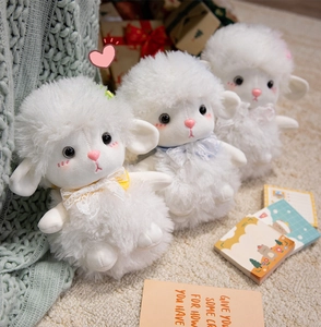 Detailed close-up of three plush sheep toys with soft lamb wool and colorful lace bows