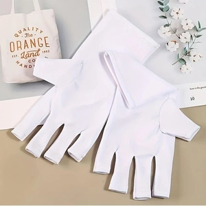 Detailed view of white UV protection manicure gloves on a clean aesthetic background