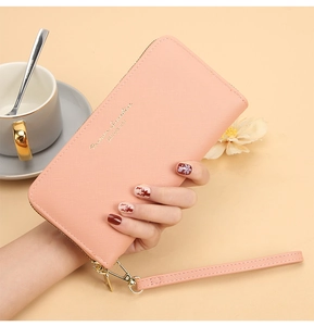 Pink long zip-around wallet in PU leather with gold hardware and a wrist strap