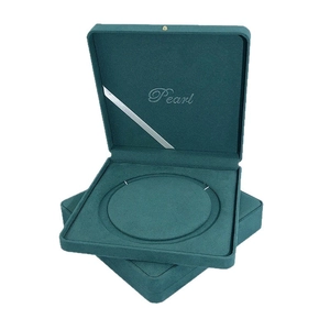Dark teal velvet jewelry box for pearl necklace storage with a silver Pearl logo