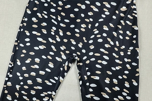 Close-up of flexible high-elastic fabric with stylish polka dot print on slim-fit pants