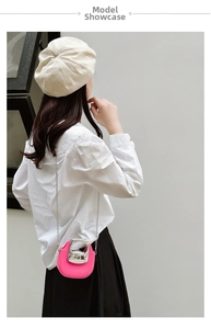 Mini pink jelly crossbody bag with silver chain strap shown worn by a model