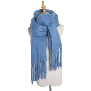 Detail shot of blue mohair scarf featuring long fringe tassels and thick cable knit texture
