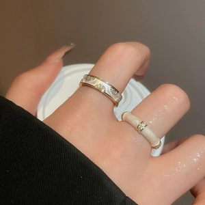 Detailed macro of 18k gold plated double layer crossover ring with white enamel and zircons