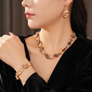 Elegant model wearing vintage enamel jewelry set with red teardrop fish patterns