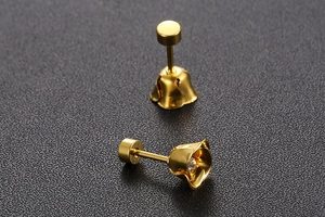 Close-up of gold flower stud earrings with crystal center and flat back screw design