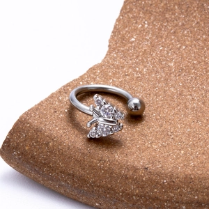 Silver stainless steel C-shaped lip ring with zircon butterfly flower on textured stone