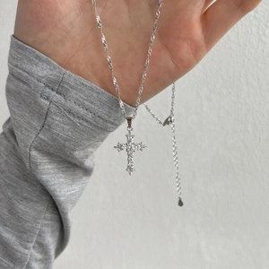 Close-up of S925 sterling silver cross necklace with sparkling cubic zirconia stones