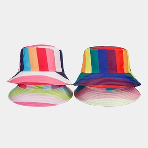 Flat lay view of four colorful rainbow striped bucket hats for summer outdoor sun protection