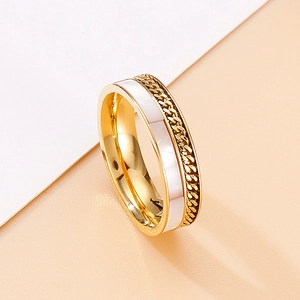 Close-up of gold stainless steel ring featuring white shell inlay and chain link texture