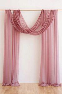 Detail of mauve chiffon wedding arch draping with elegant sheer texture and soft hang