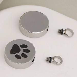 Stainless steel pet urn pendant with black paw print and threaded sealing screw