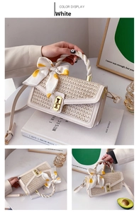 Close-up of cream woven handbag with metal twist lock and decorative silk scarf detail