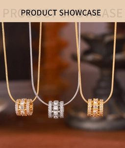 Close-up of gold and silver cylinder pendants encrusted with clear cubic zirconia