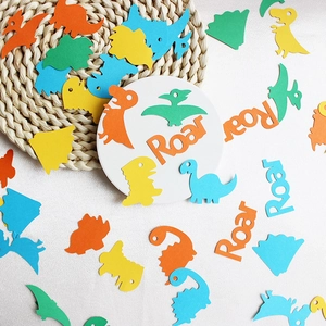 Colorful dinosaur party confetti with Roar letters for birthday table decoration