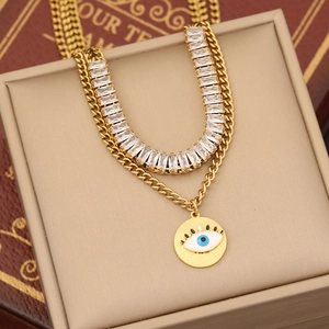 Detail of gold double-layer necklace with zircon and evil eye pendant in a box