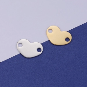 Detailed view of silver and gold heart pendants with dual holes for DIY jewelry