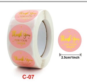 Detail of 1-inch pink and gold Thank You stickers roll for business packaging