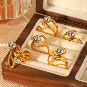 Minimalist bicolor titanium steel rings with silver sphere accents in a wooden jewelry box