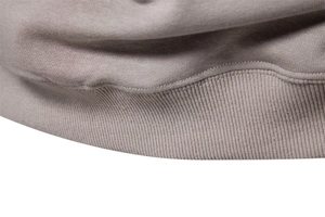 Macro detail of dark grey ribbed knit fabric and seamless stitching on causal sweatshirt