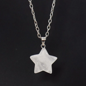 Close-up of translucent star-shaped natural crystal pendant on a delicate silver chain