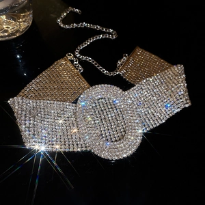 Macro detail of luxury silver choker featuring oval centerpiece and dense rhinestone weaving