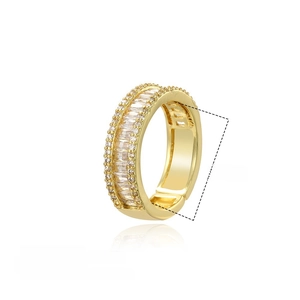 Macro detail of 18K gold plated copper ring with baguette and round zircons