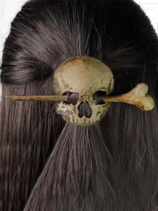 Detail shot of a faux bone skull hair pin stick slide in realistic vintage finish