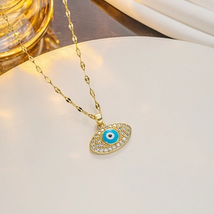 Macro shot of evil eye pendant with blue enamel and crystal inlay on gold chain
