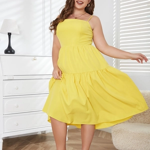 Detail of yellow plus size tiered maxi dress with thin straps and ruffled hem design
