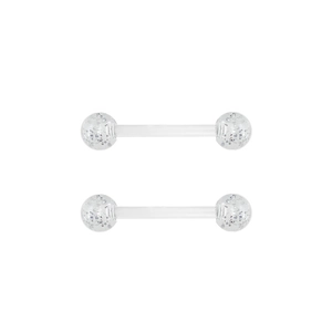 Macro view of clear acrylic nipple bar piercings with silver glitter decorative balls