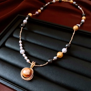 Collier de perles multicolores de luxe avec pendentif doré et diamants sur cuir noir