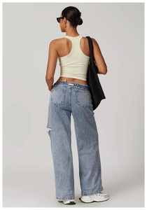 Vue arrière d'un mannequin portant un débardeur de yoga côtelé blanc cassé et un jean bleu