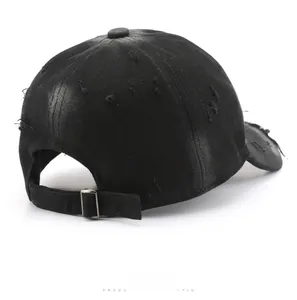 Rear view of washed black cotton baseball cap with distressed details and metal buckle