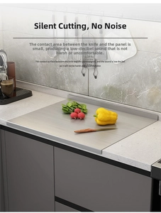 Detail of stainless steel cutting board with folded edge on marble countertop