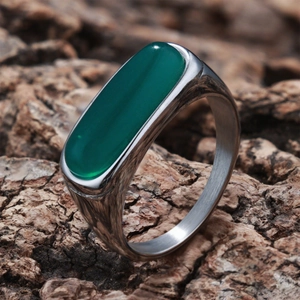 Macro shot of green agate gemstone on vintage brushed silver metal ring band