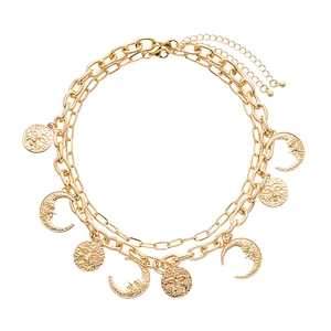 Vintage gold layered necklace featuring engraved sun and moon face medallion charms
