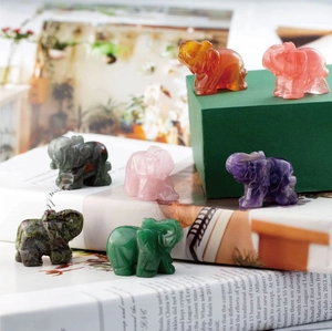 Group of seven small carved natural crystal elephants in various healing gemstones