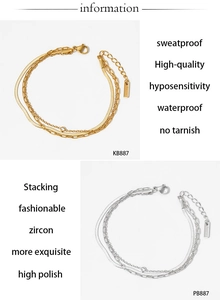 Detail of waterproof layered bracelets in gold and silver with zircon accents