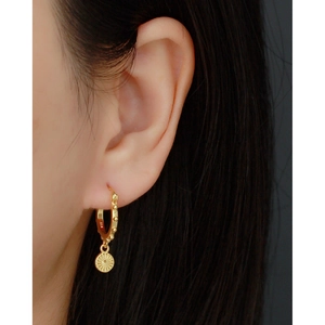 S925 sterling silver gold plated hoop earrings with round medallion pendant worn by model