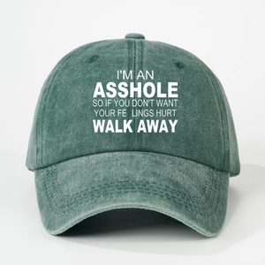 Close-up of vintage washed green baseball cap featuring white bold printed slogan