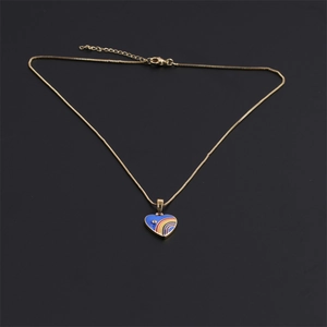 Detail of gold heart pendant with blue finish, rainbow stripes and small diamond accent